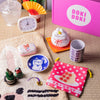 The Doki Doki Kawaii Crate by Japan Crate features kawaii Japanese-themed items like a clock, ceramic dishes, mug, pouch, figurines, and more—perfectly displayed on a tatami mat.