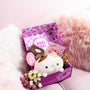 A Doki Doki Kawaii Crate by Japan Crate, filled with kawaii Japanese plushies, flowers, and stationery, sits on a light pink sofa with fluffy pillows. thumbnail 7