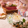 A picnic spread featuring cheese, crackers, flower bouquets, and canned drinks on lace, with Japan Crate’s Doki Doki Kawaii Crate& thumbnail 4