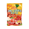 A vibrant package of Kasugai Fruitia Gummy Assort features illustrations of lychee, mango, and strawberry. The packaging emphasizes the