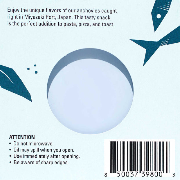The packaging of Bokksu's Tinned Shirasu Anchovies with Black Pepper and Basil-Infused Oil (4-Pack) features detailed instructions and a barcode showcasing its Miyazaki Port, Japan origin. Enhanced with umami-rich basil-infused oil, it advises against microwaving, cautions about potential oil spills, and notes the presence of sharp edges.
