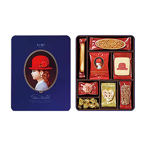 Akai Bhoshi: Blue Gift Box by Bokksu Market is a premium selection of assorted snacks, including cookies and candies, housed in a tin box with a blue lid featuring the profile of a child in a red hat.