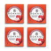 Four boxes of Bokksu White Strawberry 6-Piece Box (4-Pack), each containing six pieces of whole, ripe, freeze-dried strawberries covered in white chocolate. This artisanal Japanese snack from Bokksu comes in red packaging with an image of a strawberry.