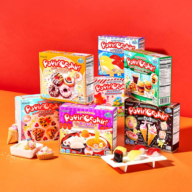 The DIY Candy Kit Pack (6-Pack) by Bokksu Market is showcased against a vibrant red background, with delightful examples of homemade candy displayed in front.
