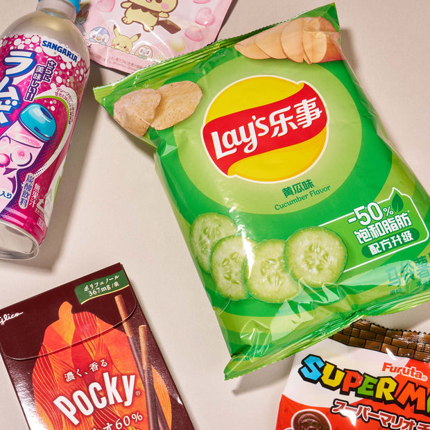 The Snack Attack Lucky Bag by Bokksu Market features authentic Asian snacks like Lay’s cucumber chips, chocolate Pocky, Sangaria Ramune, and Furuta Super Mario candy—perfect for Japanese snack lovers and mystery bag fans.