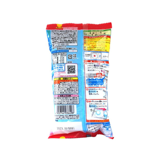 The back features a playful design with Japanese text, a QR code, and whimsical illustrations. The red-edged package from Bokksu Market offers the Meiji DIY Candy Cloud: Bubble Gum experience with yogurt-flavored powder inside.