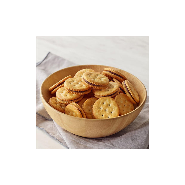 A wooden bowl on a fabric surface holds Bokksu Market's Mondelez Ritz Crackers: Chocolate (12 pcs)—round, creamy chocolate-filled sandwich crackers offering a sweet and salty treat to satisfy any craving.