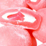 A close up of Kubota Daifuku Mochi: Strawberry gummy bears on a white surface. thumbnail 2