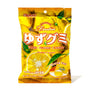 A bright yellow package of Kasugai Frutia Yuzu Gummy, featuring images of yuzu fruits, labeled "Fruity & Soft," "Gluten Free," and "Product of Japan," weighs 3.59 oz (102g). This refreshing summery treat offers the delightful taste of gummy candies with a tangy yuzu flavor. thumbnail 1