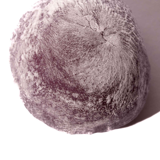 A Kubota Daifuku Mochi: Blueberry on a white surface.