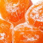 Close-up of sliced, sugared apricots with visible frost particles, highlighting their vibrant orange color and juicy texture with a hint of Seiki One-Bite Mochi: Melon Choco filling. thumbnail 3