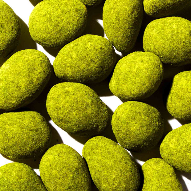 A pile of HBAF Jeju Island green rocks on a white surface.