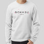 A man wearing a Bokksu Crewneck Sweatshirt: Sakura 2023 with the word Bokksu on it. thumbnail 1