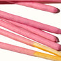 A bunch of Glico Pocky: Strawberry sticks on a white surface. thumbnail 2
