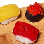 Three different kinds of Kracie Popin Cookin DIY Candy: Sushi on a wooden cutting board. thumbnail 2