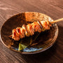 Spicy Japanese yakisoba skewers served with Ocean Foods Yuzu Kosho Pepper: Red Label on a black plate. thumbnail 4