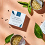 Cans of Bokksu Tinned Shirasu Anchovies with Black Pepper and Basil-Infused Oil (3-Pack) are displayed on a textured surface alongside fresh basil leaves. One opened can reveals its contents, perfect for elevating your umami spaghetti experience. thumbnail 3