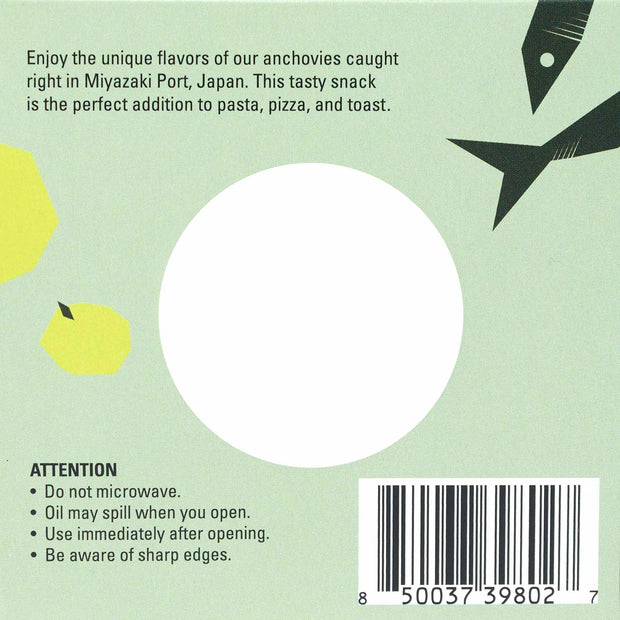 A Bokksu Tinned Shirasu Anchovies with Yuzu Pepper (2-Pack) label showcasing shirasu anchovies from Miyazaki Port, Japan, includes a circular translucent window and a barcode on the bottom right. Rich in protein, this label also features warnings about microwaving and oil spillage.