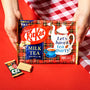 Hands holding a package of Nestlé Japan Milk Tea Kit Kat with the slogan &quot;let& thumbnail 3