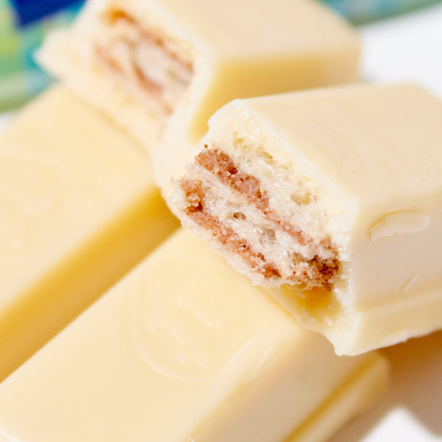 A Japanese Kit Kat: Milk Tea bar with a piece cut out of it, made by Nestle Japan.