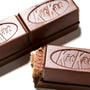 Two Japanese Kit Kat: Original Bars from Nestle Japan, one with a bite taken out showing the layers inside, isolated on a white background. thumbnail 4