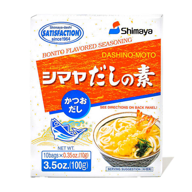 A white package of Shimaya Shimaya Dashi no Moto Soup Stock: Bonito Katsuo (10 servings) weighing 3.5 oz (100g). Contains 10 bags of 0.35 oz each. The package, perfect for enhancing ramen or creating authentic soup stock, features a bowl of soup and an illustration of a fish.