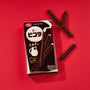 Picola Sticks: Milk flavor, displaying the sleek, dark biscuit sticks artfully arranged around their stylish package against a vivid red background. Brand: Bokksu Market; Product: YBC Black Picola Sticks: Milk (10 pieces). thumbnail 2