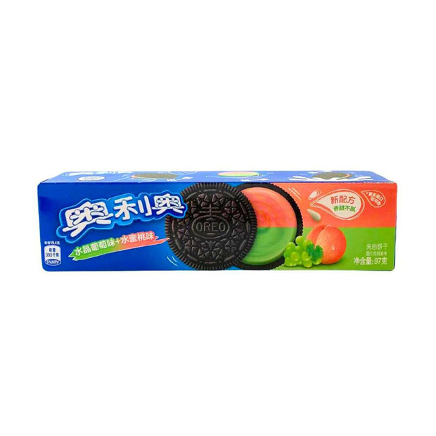 A package of Oreo Double Fruit Sandwich Cookies Grape & Peach features grape, peach, and cookie images on a blue background with Chinese text, highlighting fruity options like grape and peach frosting.