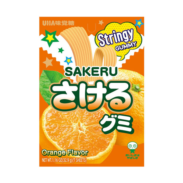 The image features a package of Uha Sakeru Gummy: Orange (7 pieces) by Uha Mikakuto, vividly showcasing its orange-flavored gummy candy with bright graphics, a peeled orange illustration, and Japanese text. The vibrant packaging highlights "Stringy Gummy" in a bubble, emphasizing its peelable gummy candy appeal.