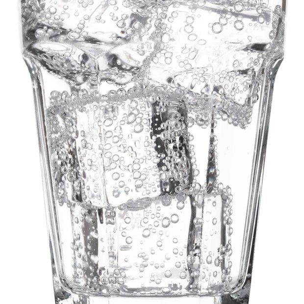 A glass of Sangaria Ramune Soda: Peach with ice cubes in it.