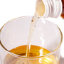 A bottle of Itoen Jasmine Green Tea is being poured into a glass. thumbnail 2