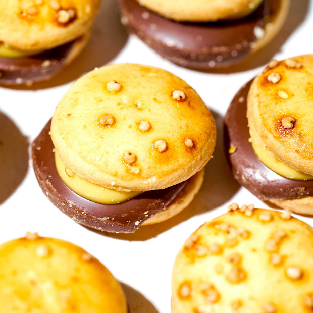 A group of Bourbon Every Burger Chocolate Cookies with chocolate and nuts on them.