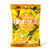A bright yellow package of Kasugai Frutia Yuzu Gummy, featuring images of yuzu fruits, labeled 