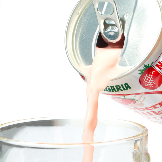 A can of Sangaria Strawberry Milk Drink being poured into a glass.