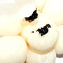 A pile of Kubota Daifuku Mochi: Black Sesame balls with a hole in the middle. thumbnail 3