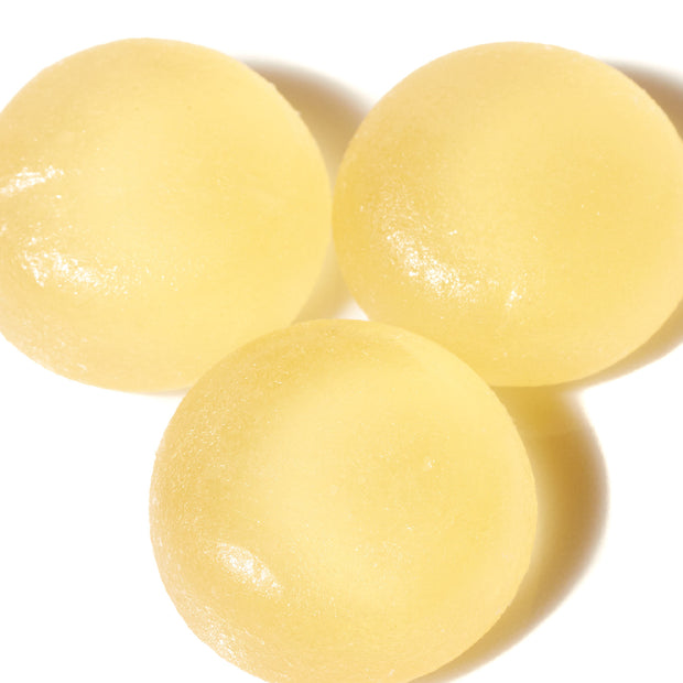 Three Kasugai Frutia Lychee Gummy on a white surface.