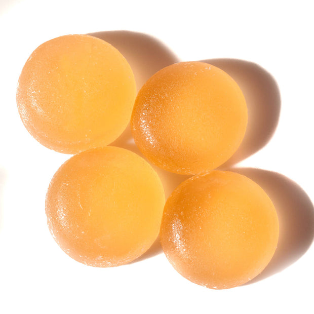 A group of Kasugai Frutia Watermelon Gummy balls on a white surface.