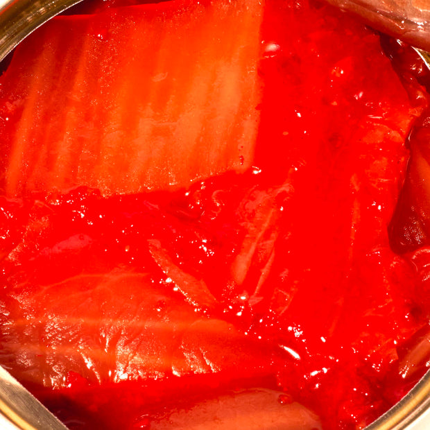 A can of Wang Tinned Napa Cabbage Kimchi with a spoon in it.