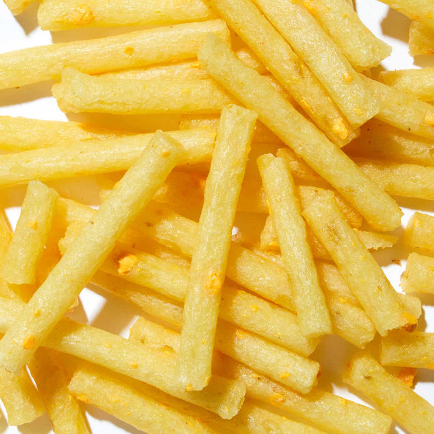 A pile of Calbee Jagarico: Double Cheese on a white surface.