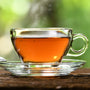 A cup of Butterfly Hong Kong Style Breakfast Tea (100 bags) with a spoon on a wooden table. thumbnail 2