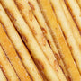 A close up of a bunch of Glico Pretz: Sour Cream &amp; Onion sticks with sugar on them. thumbnail 2
