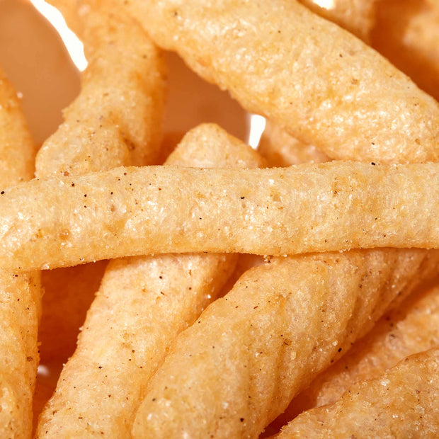 A close up of Calbee Shrimp Chips: Yuzu Pepper on a plate.