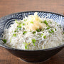 A bowl of Bokksu Tinned Shirasu Anchovies with Black Pepper and Basil-Infused Oil, noodles and green onions. thumbnail 5